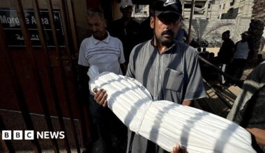 The body of 13-year-old Abdul Hamid al-Ghalban, who died as a result of malnutrition, is carried in a white shroud before his funeral, at Nasser hospital in Khan Younis, southern Gaza (22 July 2025)