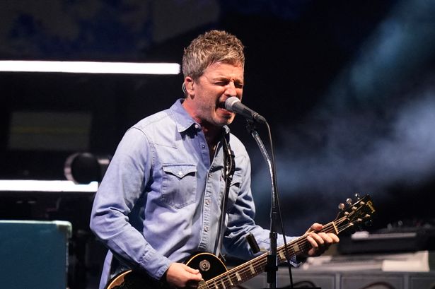 Noel Gallagher, singer and guitarist of British rock band Oasis performs on stage at the Principality Stadium in Cardiff on July 4, 2025,