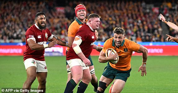 Australia's Jake Gordon (R) scores a try during the second rugby Test match against the British and Irish Lions at the Melbourne Cricket Ground (MCG) on July 26, 2025. (Photo by WILLIAM WEST / AFP) / -- IMAGE RESTRICTED TO EDITORIAL USE - STRICTLY NO COMMERCIAL USE  (Photo by WILLIAM WEST/AFP via Getty Images)