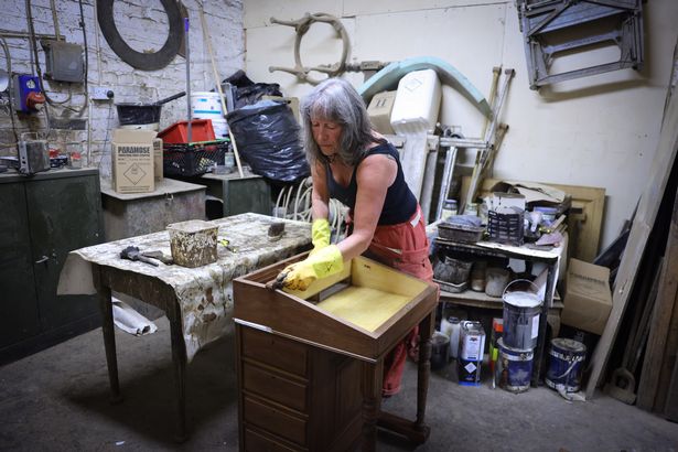 Nicky, a furniture restorer at work