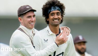 Dan Lawrence has his arms around Surrey team-mate Sai Kishore