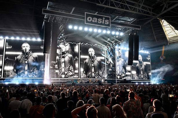 Oasis perform on stage at Principality Stadium in Cardiff