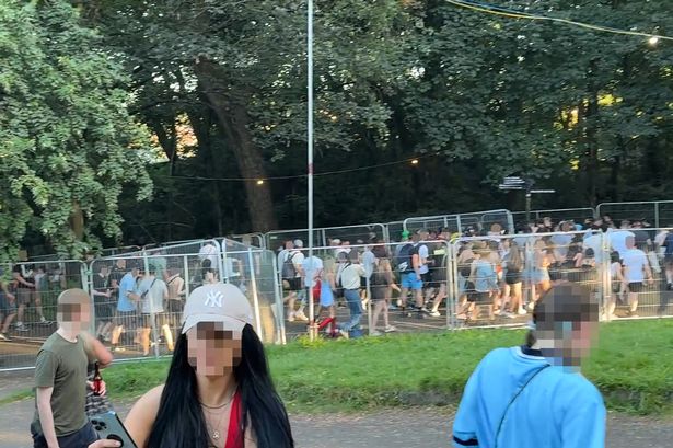 People streamed through metal fences as Oasis took to the stage