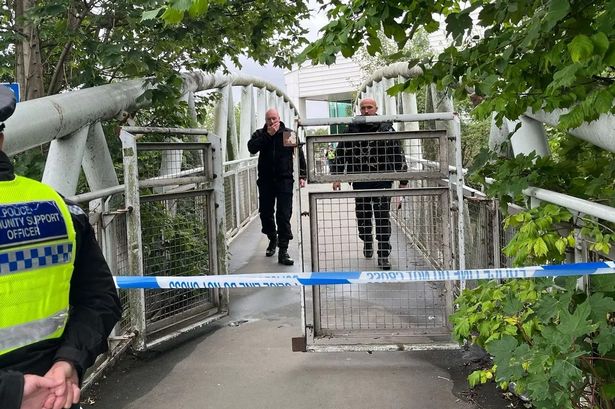 Police officers on the footbridge over the river Calder to Asda, Dewsbury