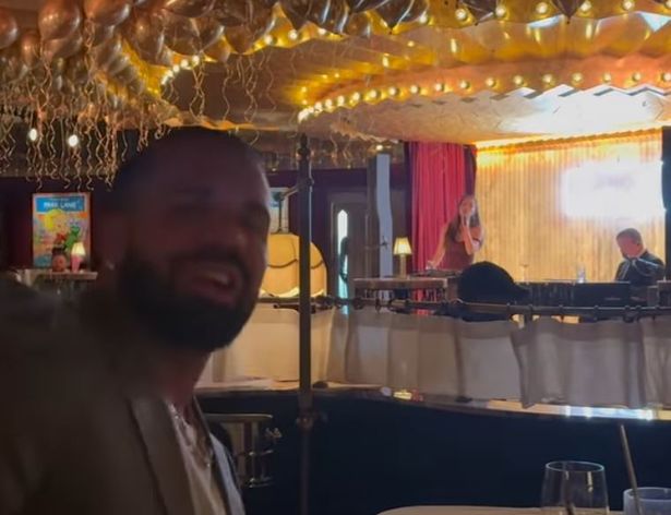 Drake was seen singing as he enjoyed a drink at the Louis restaurant