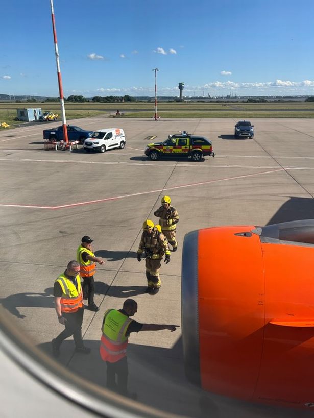 Emergency services inspect an engine on an easyJet flight after it returned to Liverpool airport 