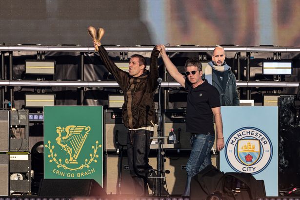 The Gallagher brothers arrive on stage for the Oasis show at Heaton Park