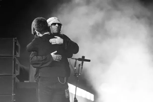 Noel and Liam Gallagher hugging