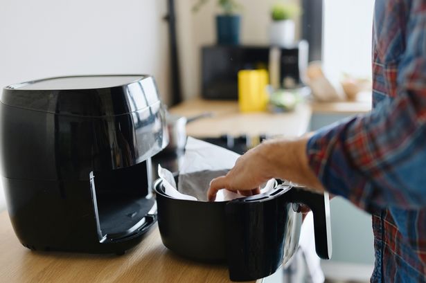 man preparing food in the Air Fryer