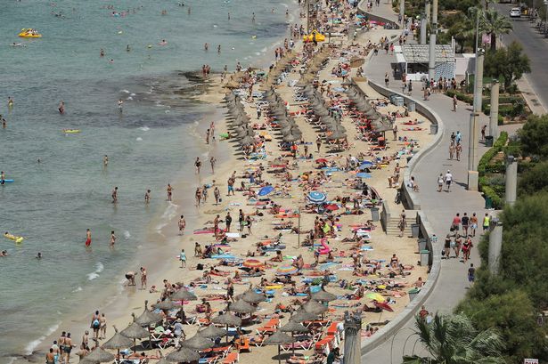 Visitors crowd the beach along the Ballermann stretch in Palma de Mallorca