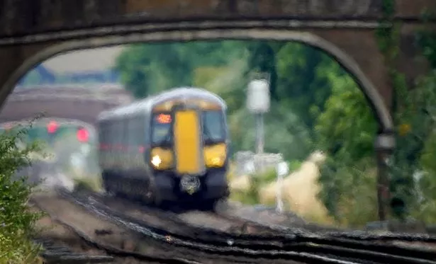 A train passes through heat haze on a railway line 