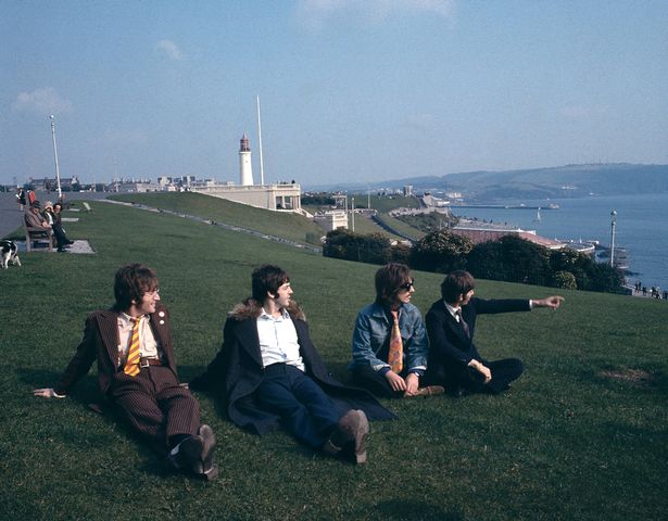 From left, John Lennon, Paul McCartney, George Harrison and Ringo Starr sit together on Plymouth Hoe during filming of the television musical film 'Magical Mystery Tour' on 12th September 1967