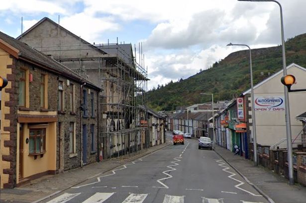 A street with a hotel with scaffolding 