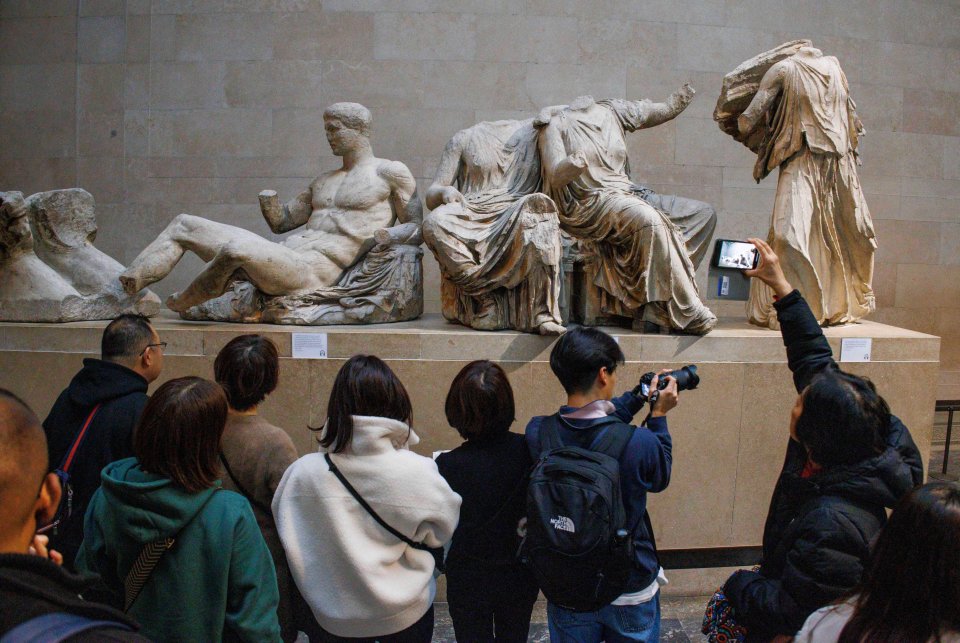 Visitors viewing the Parthenon sculptures at the British Museum.