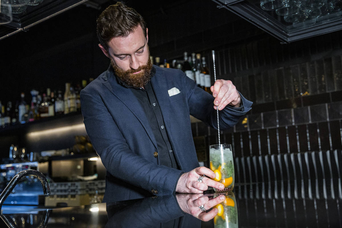 a bartender mixing a drink at the bar at kanpai classic