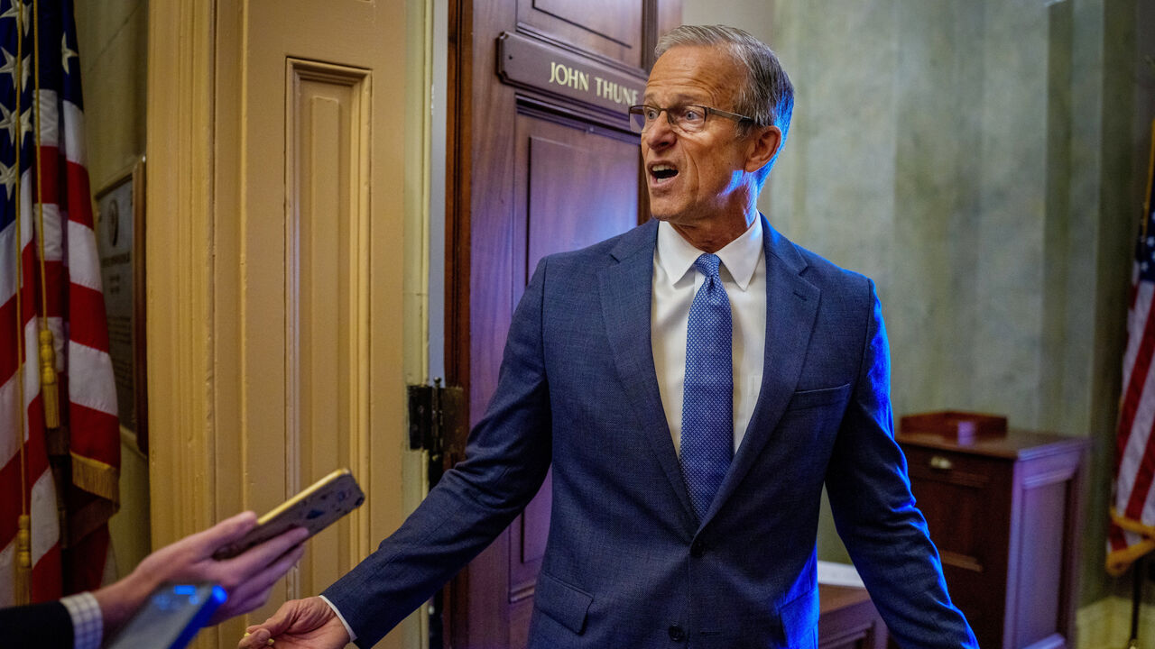 Senate Majority Leader John Thune (R-SD) speaks to reporters as he returns to his office from the Senate Chamber.
