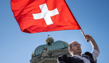 A flag thrower performs with a Swiss flag in Bern, Switzerland