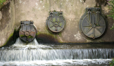 Water discharges from an outlet pipe into the River Mersey next to waste water treatment plant