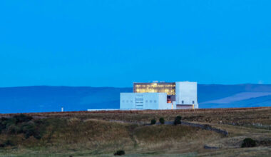 Torness nucelar power station lit up at dusk, in Scotland, UK.