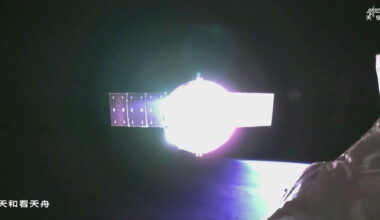 A space craft reflects light in the darkness of space