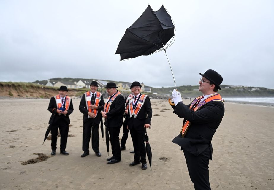 An Orange order member gets his umbrella out at Rossnowlagh on July 5, 2025 in Donegal, Ireland.  (Photo by Charles McQuillan/Getty Images)