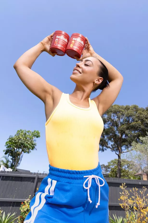 Person holding up a tub of supplement power