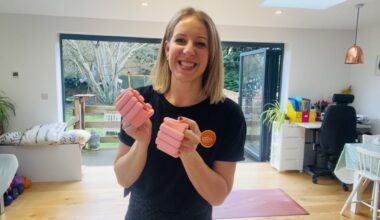 Woman holds pink wrist weights in her hands