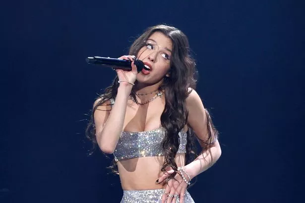 Olivia Rodrigo singing on stage in Nashville in 2024