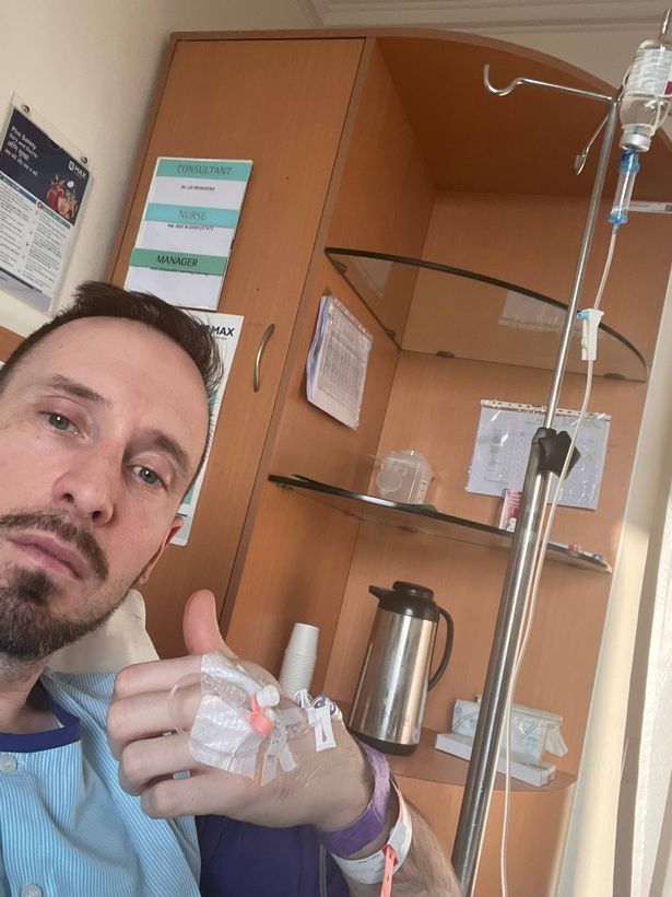 Picture showing Steven sitting in a room in a medical setting with an IV going into his hand