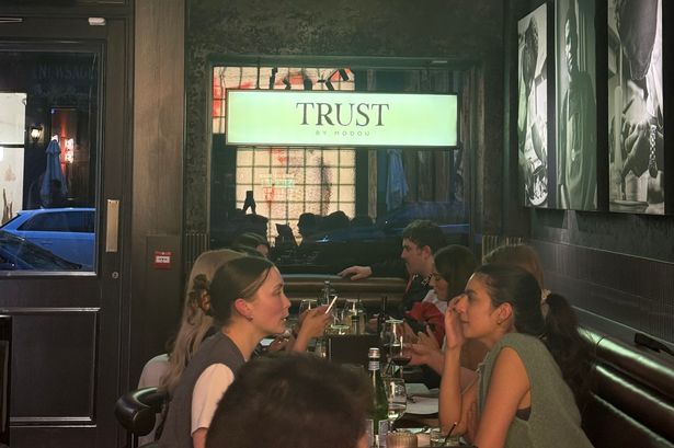 Diners eating in TRUST by Modou