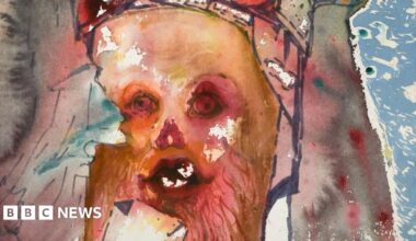 Part of a painting by Salvador Dali. It shows a face in orange and red colours.