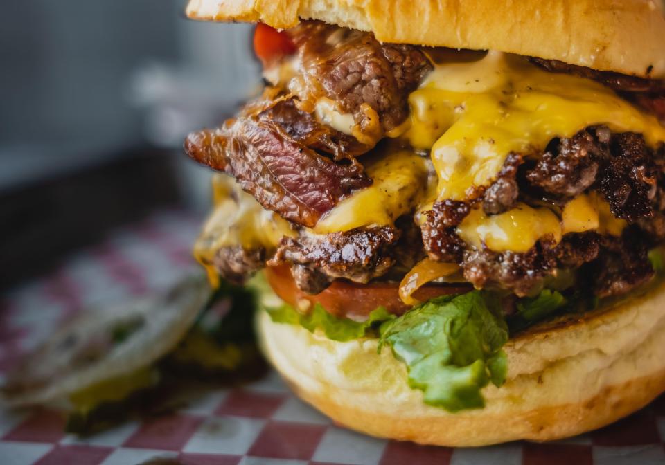 Close-up of a cheeseburger with bacon.