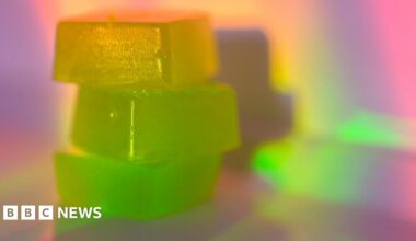 Three brightly coloured gummy-style sweets stacked on top of each other