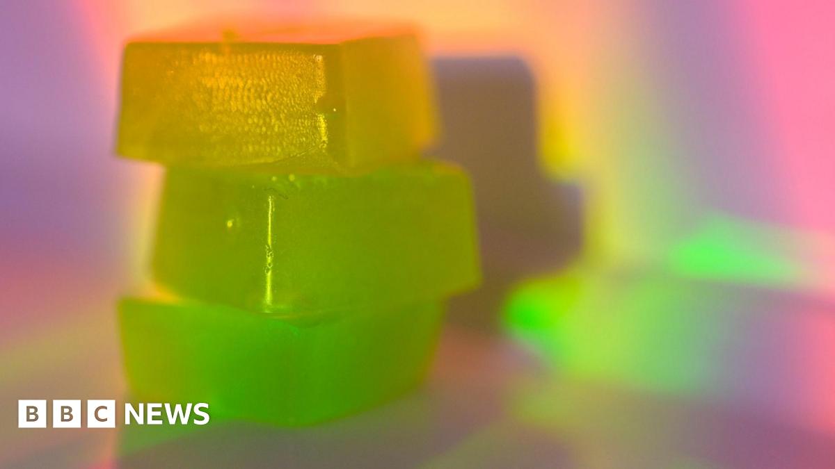 Three brightly coloured gummy-style sweets stacked on top of each other