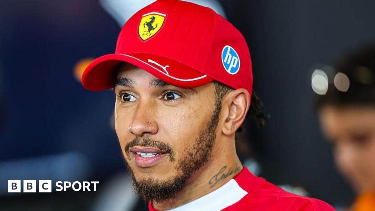 Lewis Hamilton speaking to the media at the Austrian Grand Prix wearing a Ferrari cap