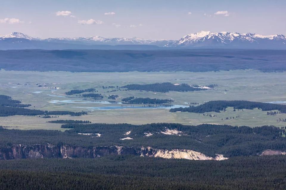 A view of the Yellowstone caldera from the Washburn Range on July 1, 2017. The caldera extends to the base of the Red Mountains in the upper right of the photo. The rim of the Grand Canyon of the Yellowstone is in the foreground.