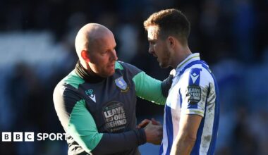 Henrik Pedersen (left) talking to former Sheffield Wednesday player Will Vaulks on the pitch