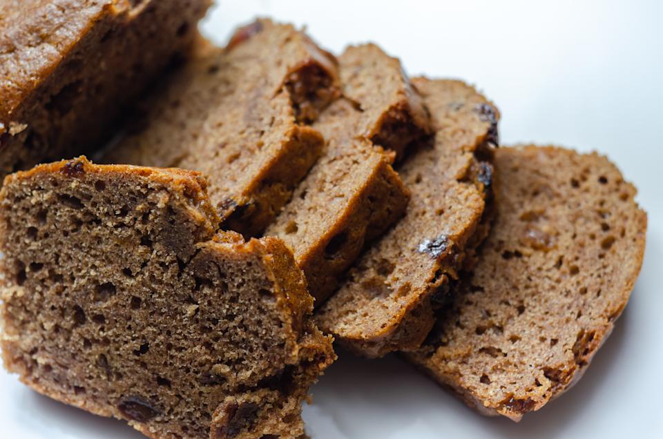 Freshly made spiced fruit  loaf cake  on the white  background, traditional British cake