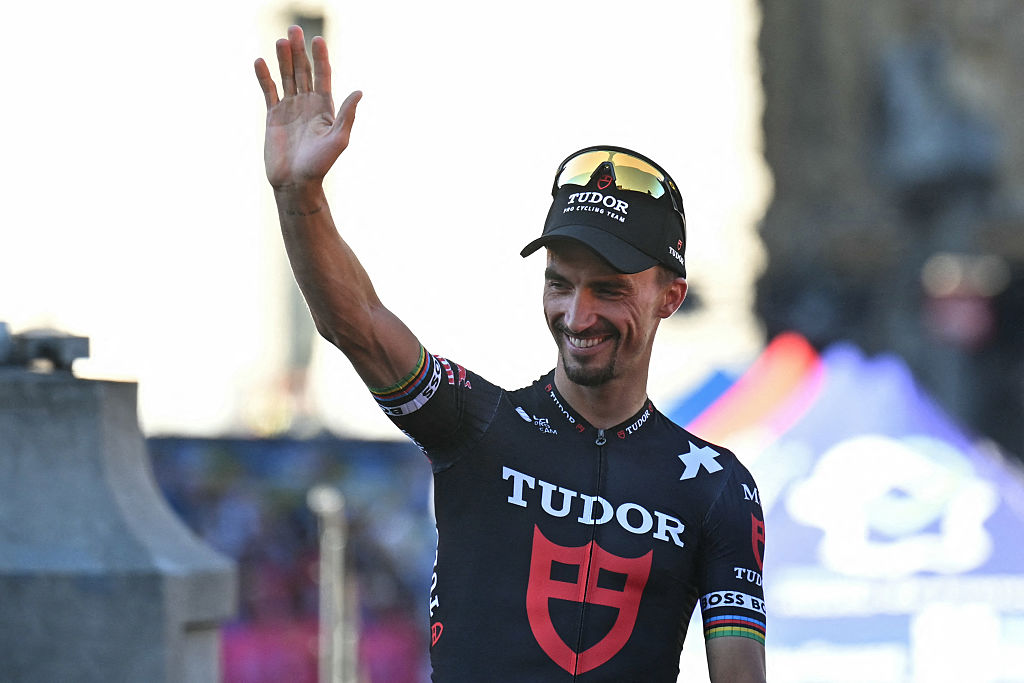 Tudor Pro Cycling Team's French rider Julian Alaphilippe waves to spectators on Lille's Grand' Place during the official teams presentation days prior to the start of the 112th edition of the Tour de France cycling race, in Lille, northern France, on July 3, 2025. (Photo by Loic VENANCE / AFP)
