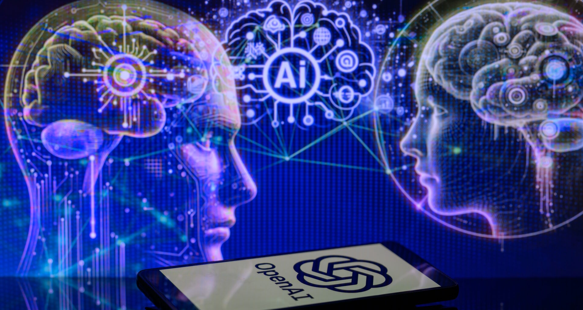The OpenAI logo is being displayed on a smartphone with an AI brain visible in the background, in this photo illustration taken in Brussels, Belgium, on January 2, 2024. (Photo illustration by Jonathan Raa/NurPhoto via Getty Images)