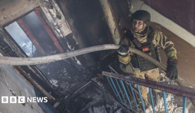 Ukrainian emergency service workers extinguish a fire in a residential building, after Russian shelling, in Kostiantynivka