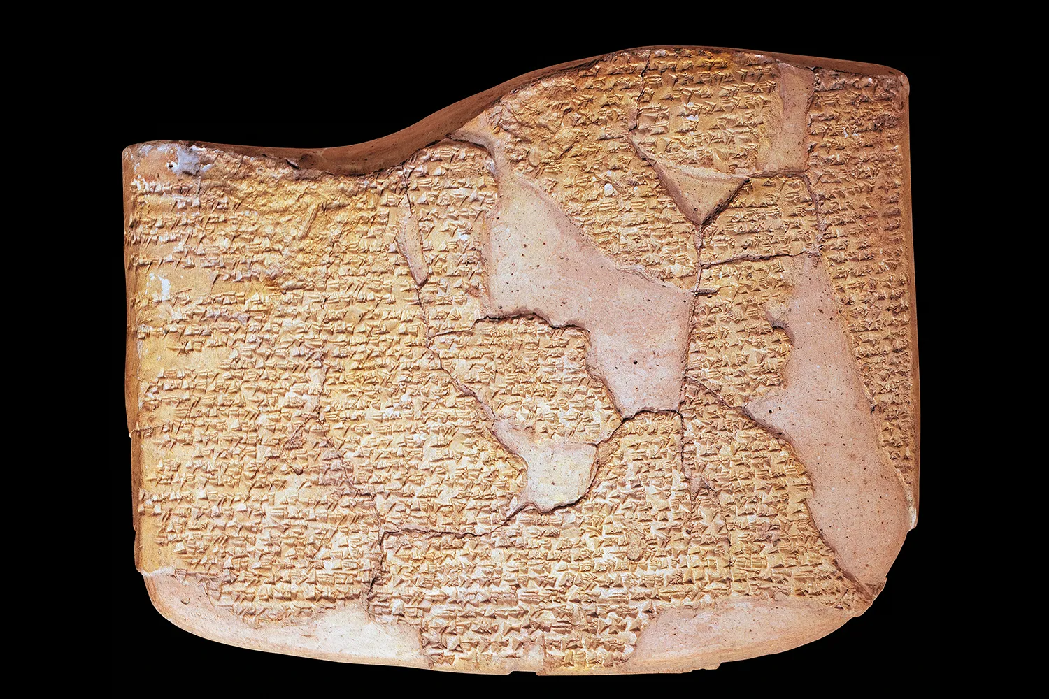 Photo of a clay tablet against a black background.