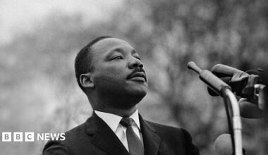 Martin Luther King Jr photographed speaking before a massive crowd in Alabama