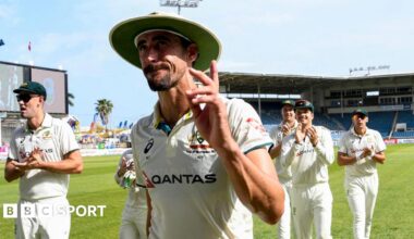 Australia quick bowler Mitchell Starc waves as he walks off, applauded by his team-mates