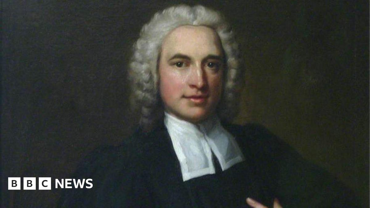 A painted portrait of Charles Wesley. He has grey curly hair and is wearing a black robe with a white cravat around his neck.
