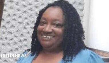 Sheffield foster carer Marcia Grant, a woman with black braided hair wearing a blue shirt.