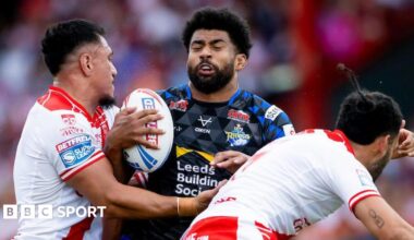 Leeds Rhinos' Kallum Watkins runs into a two-man tackle from Hull KR's Sauaso Sue and Tyrone May