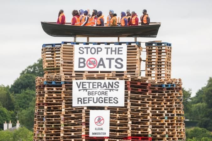 A bonfire in Moygashel, beside Dungannon in Co. Tyrone, with an effigy of a migrant boat on top of it
