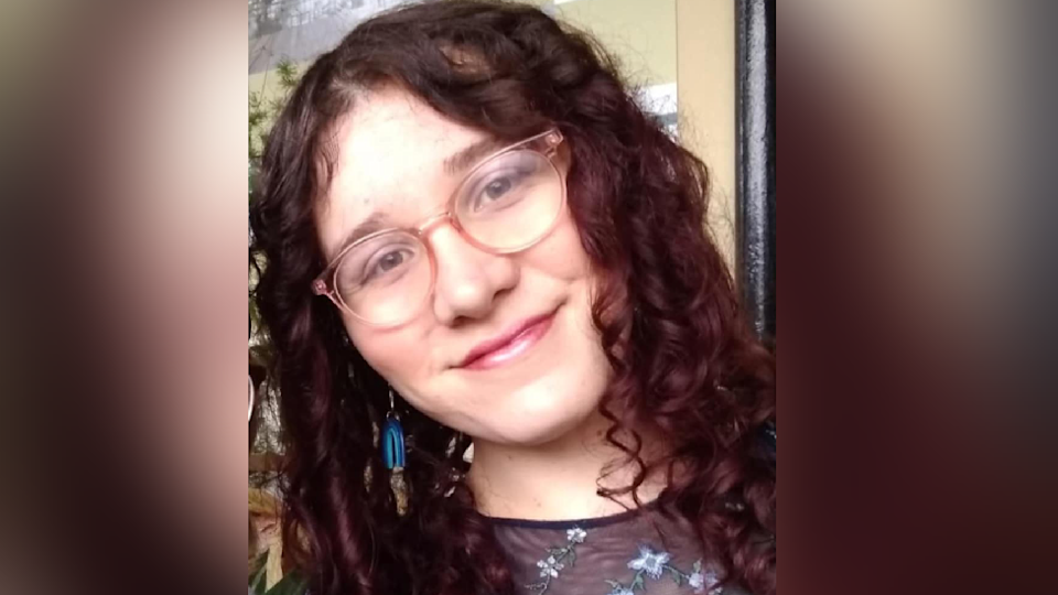 A picture of Jenny with her hair down. She is smiling at the camera. 