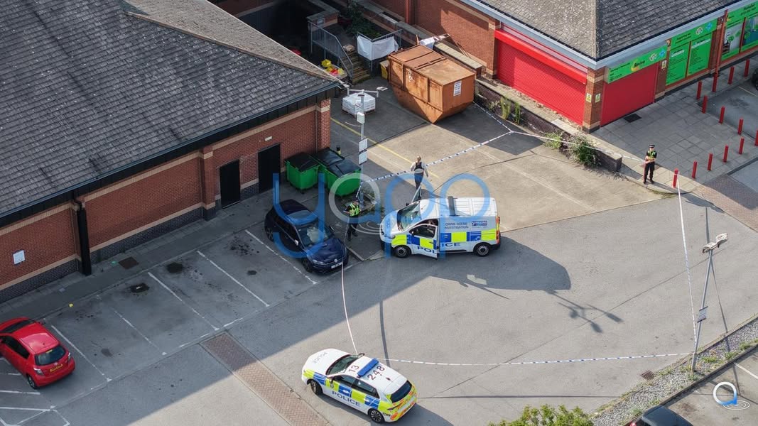 BREAKING: Body Found Behind Skip in Leeds Sparks Police Investigation An investigation has been launched after a body of a male was discovered earlier this evening behind a skip in a car park in the Hunslet area of Leeds, opposite a KFC and near a Morrisons supermarket. West Yorkshire Police have confirmed that Crime Scene Investigation (CSI) officers and detectives are actively examining the scene, which has been cordoned off to facilitate inquiries. The discovery was reported in the car park, prompting a swift response from authorities. Police have set up a cordon to preserve evidence as forensic teams work to understand the circumstances surrounding the incident. The identity of the deceased and the cause of death have not yet been disclosed, as investigations are ongoing. Local residents and shoppers in the area have expressed shock at the news, with the car park, typically bustling due to its proximity to popular retail and dining spots, now under close police scrutiny. Authorities have not released further details at this stage but are continuing their inquiries to establish the full circumstances of the discovery. The investigation remains active, with police expected to provide updates as more information becomes... - Yapp ‘App’